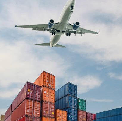 Airplane flying above container port. Cargo and shipping business in a commercial port. Container ship for import and export logistic.